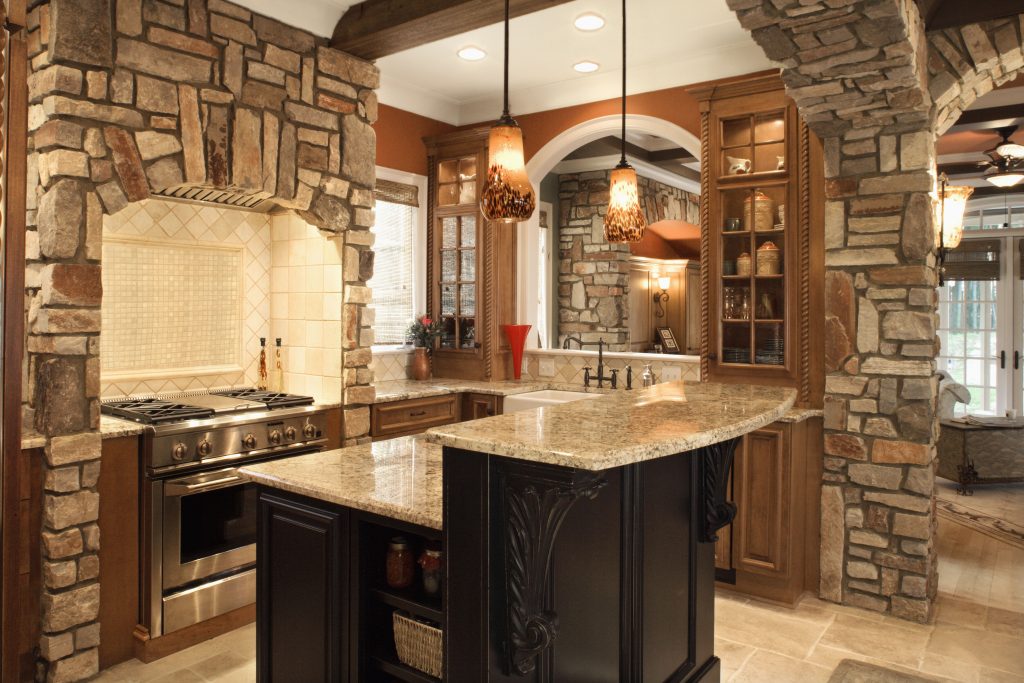 Gulf Beach upscale kitchen interior with stone accents and wood beam ceiling.